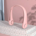 Pink portable bladeless neck fan hanging around a person's neck, showing the flexible design and air outlets.