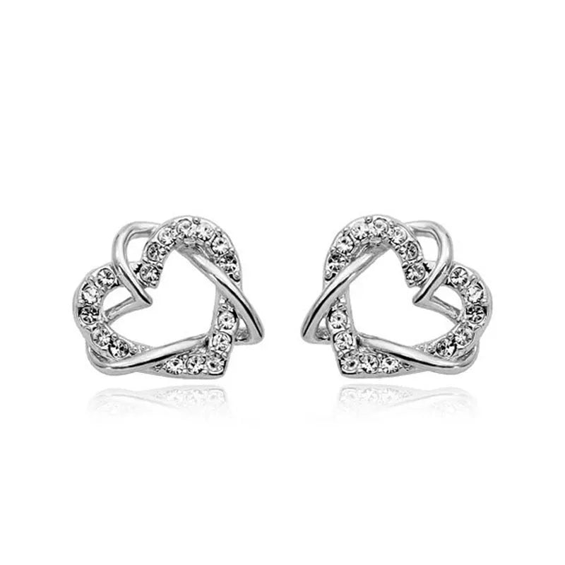 Gold colour alloy heart-shaped stud earrings on white background