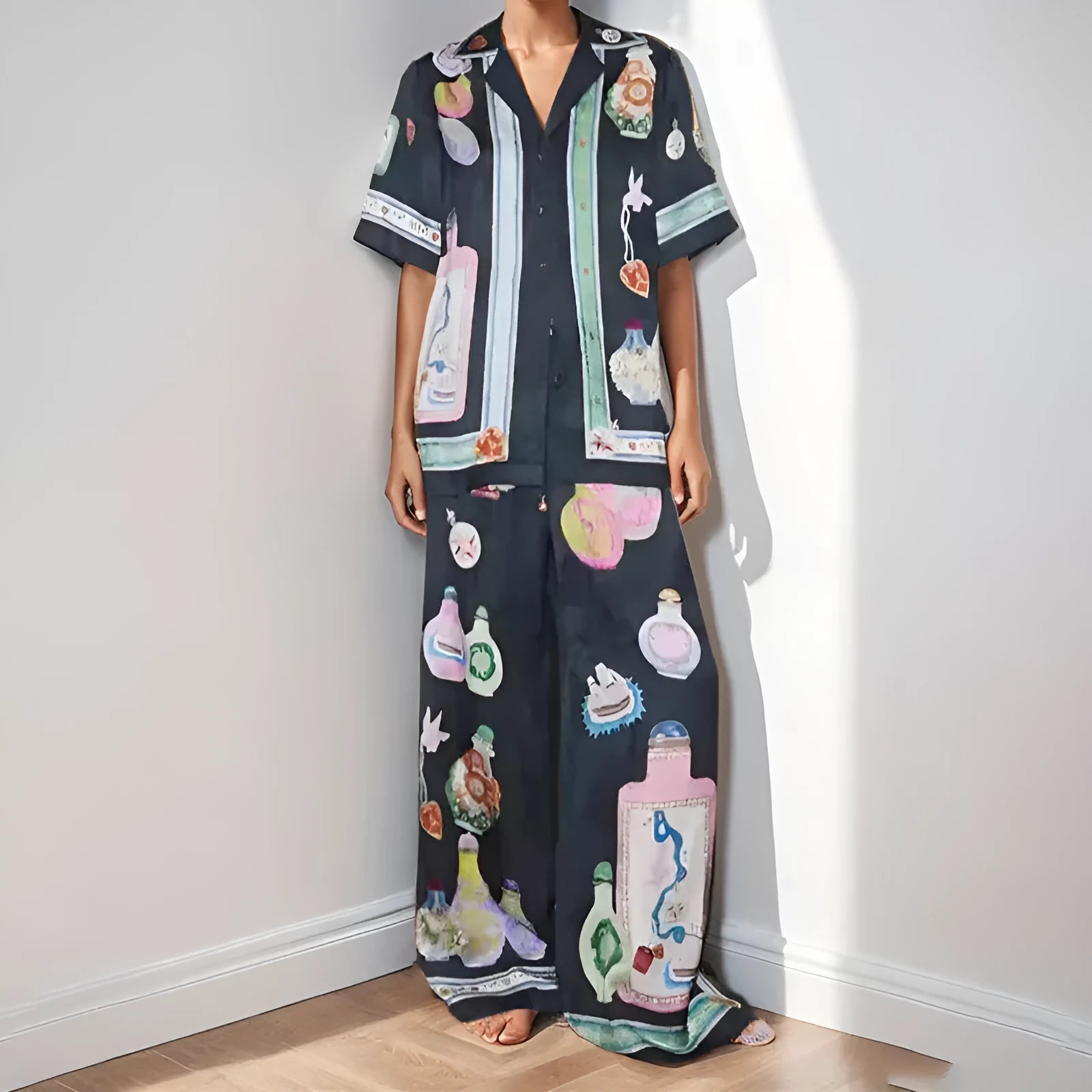 Black women's casual set with cartoon print, featuring a long-sleeve cardigan and trousers.