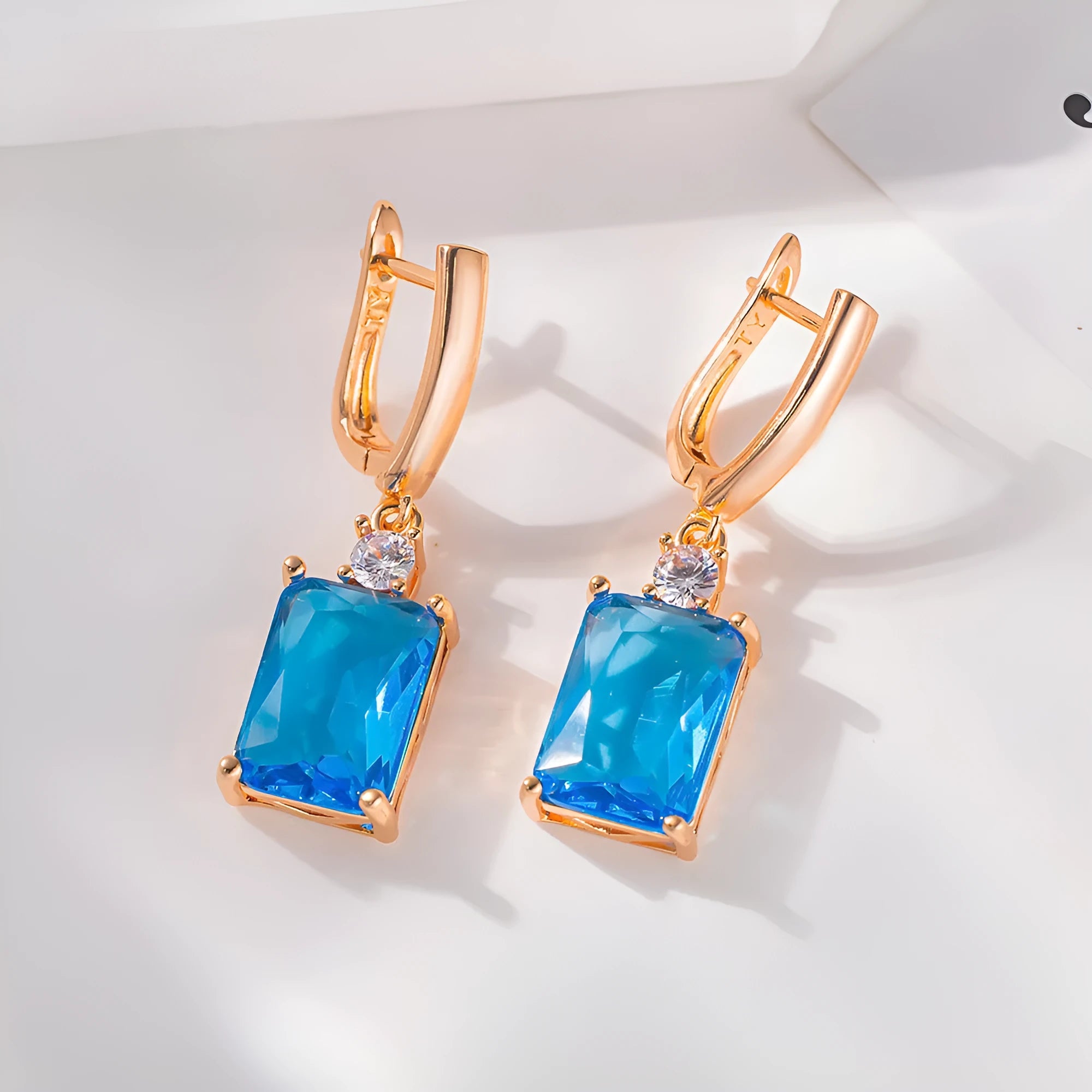 Square geometric earrings with electroplated gold or silver finish on copper, showing quadrilateral design elements