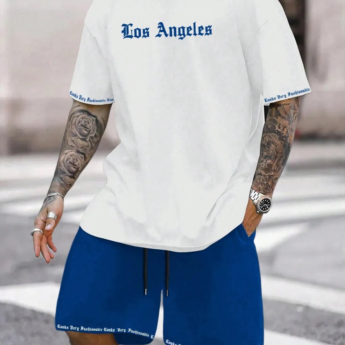 Men's grey sports short sleeve top and matching shorts set on hanger