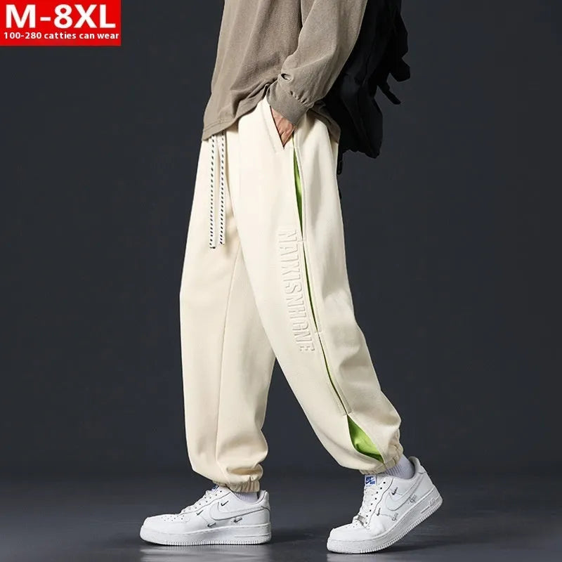 Men's loose fit cotton casual trousers with stitching print design and banded ankle cuffs.