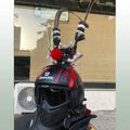 Black and gold crown with long feather plume decoration for mounting on a motorcycle helmet.