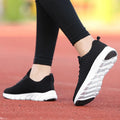 Women's running shoes in black, pink, or white with a fly weaving upper and wear-resistant outsole.