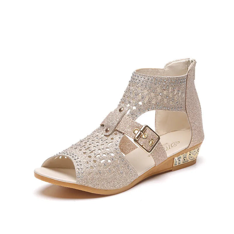 Women's beige flat sandals with fish mouth open toe and back zipper on a low wedge heel.