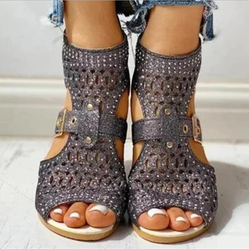 Women's beige flat sandals with fish mouth open toe and back zipper on a low wedge heel.