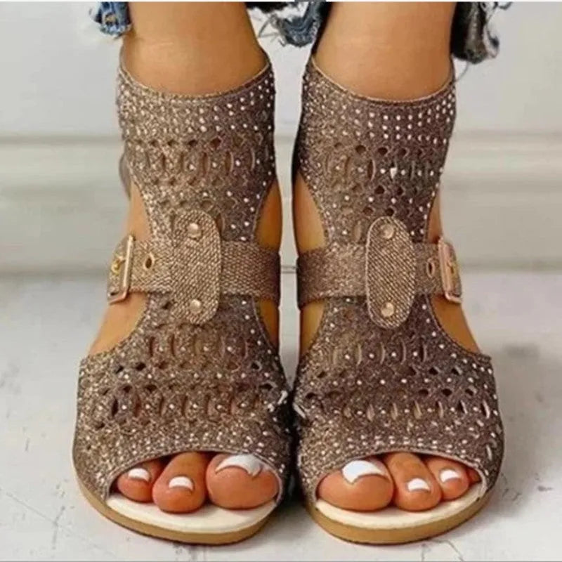 Women's beige flat sandals with fish mouth open toe and back zipper on a low wedge heel.