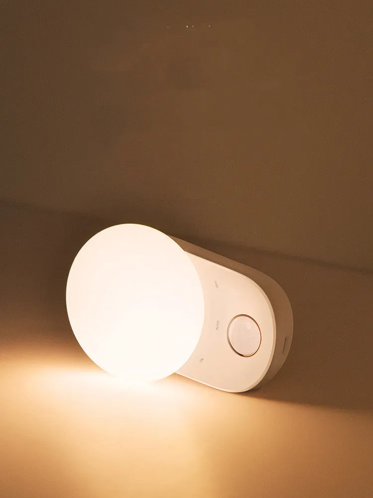 White Baseus rechargeable sensor night light with LED glow, shown on a surface.