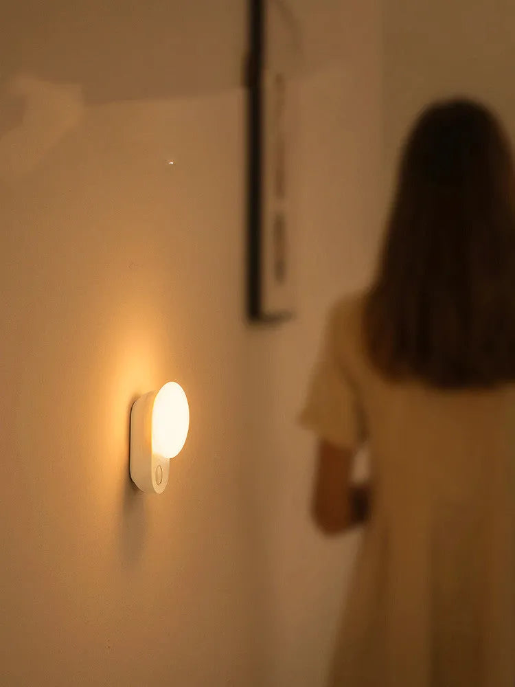White Baseus rechargeable sensor night light with LED glow, shown on a surface.