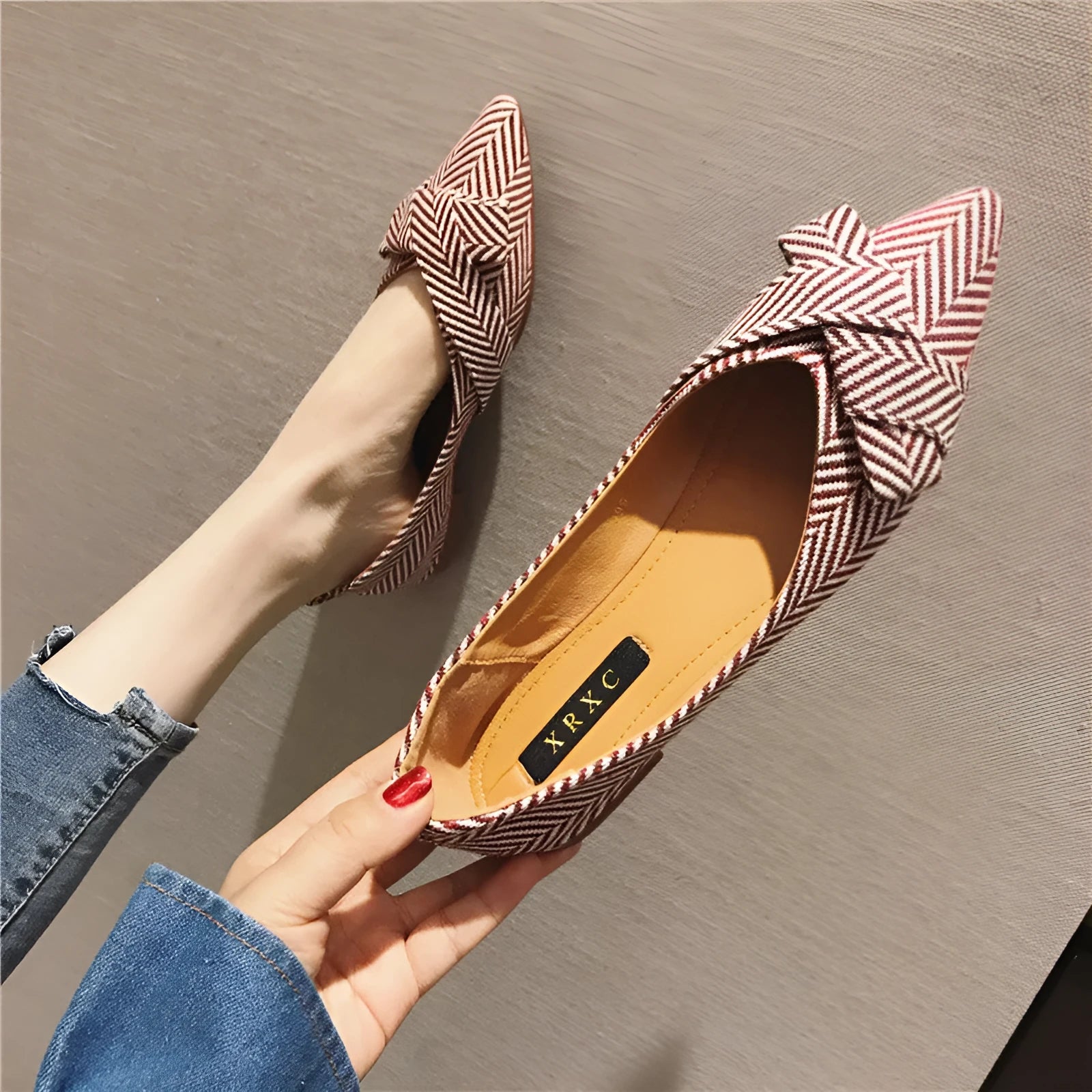 Women's black pointed toe cotton flats with a low flat heel and shallow mouth design on a white background.