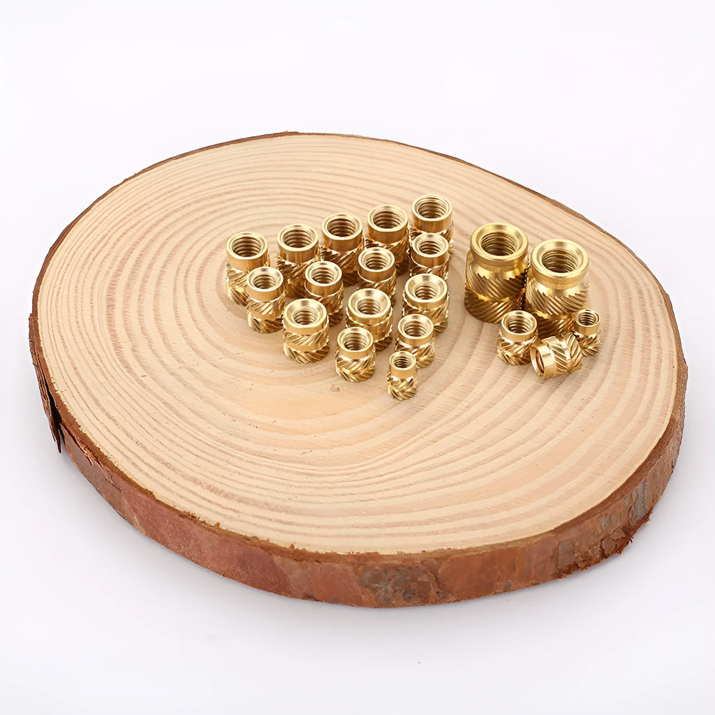 Assortment of brass hot melt copper nuts with M2 and M3 threads in various heights.