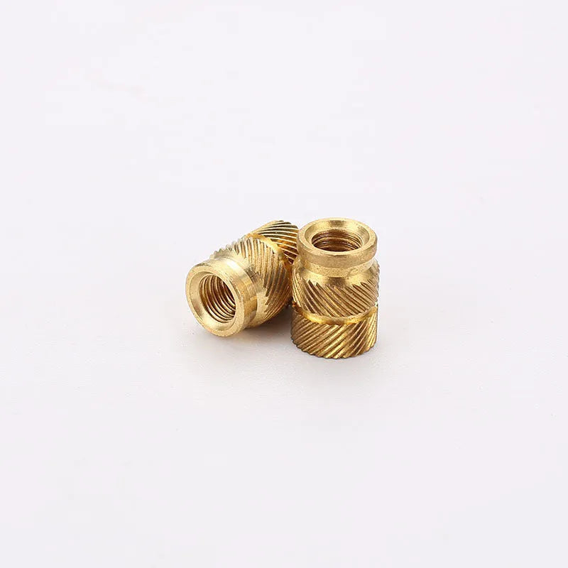 Assortment of brass hot melt copper nuts with M2 and M3 threads in various heights.