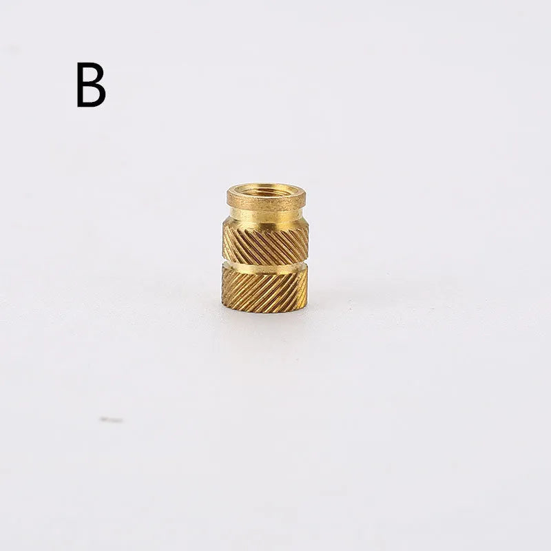 Assortment of brass hot melt copper nuts with M2 and M3 threads in various heights.