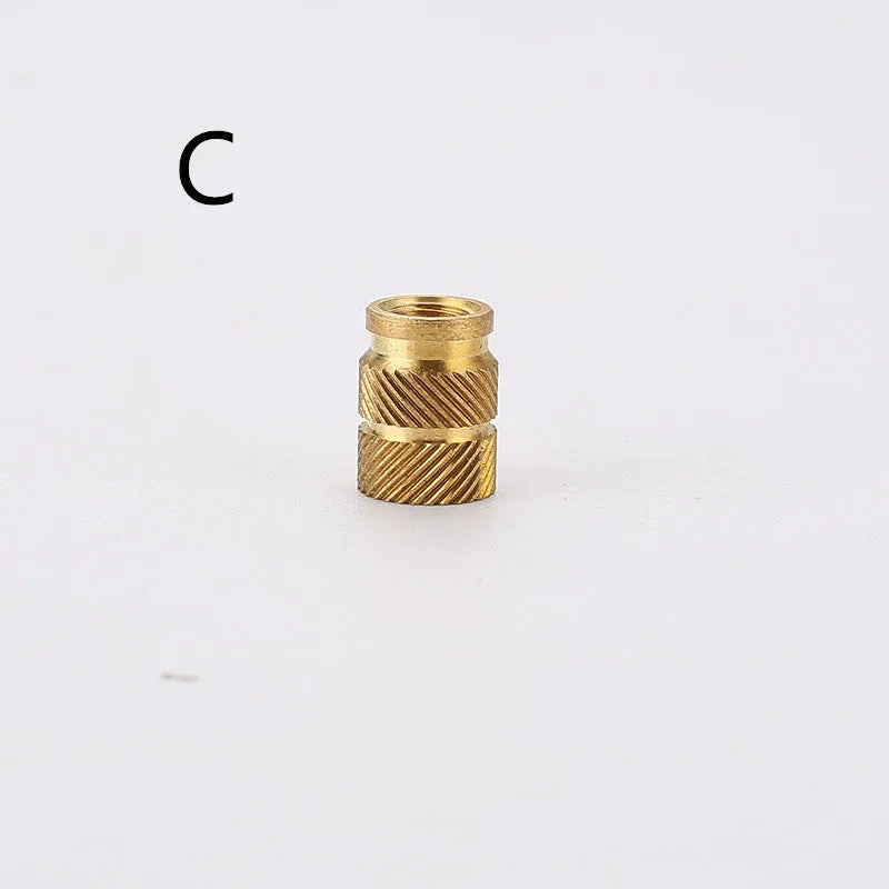 Assortment of brass hot melt copper nuts with M2 and M3 threads in various heights.