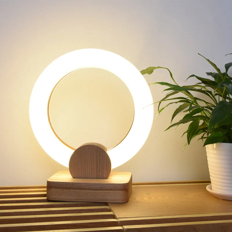 Nordic style wooden circular art chandelier with round acrylic shade in a modern living room.