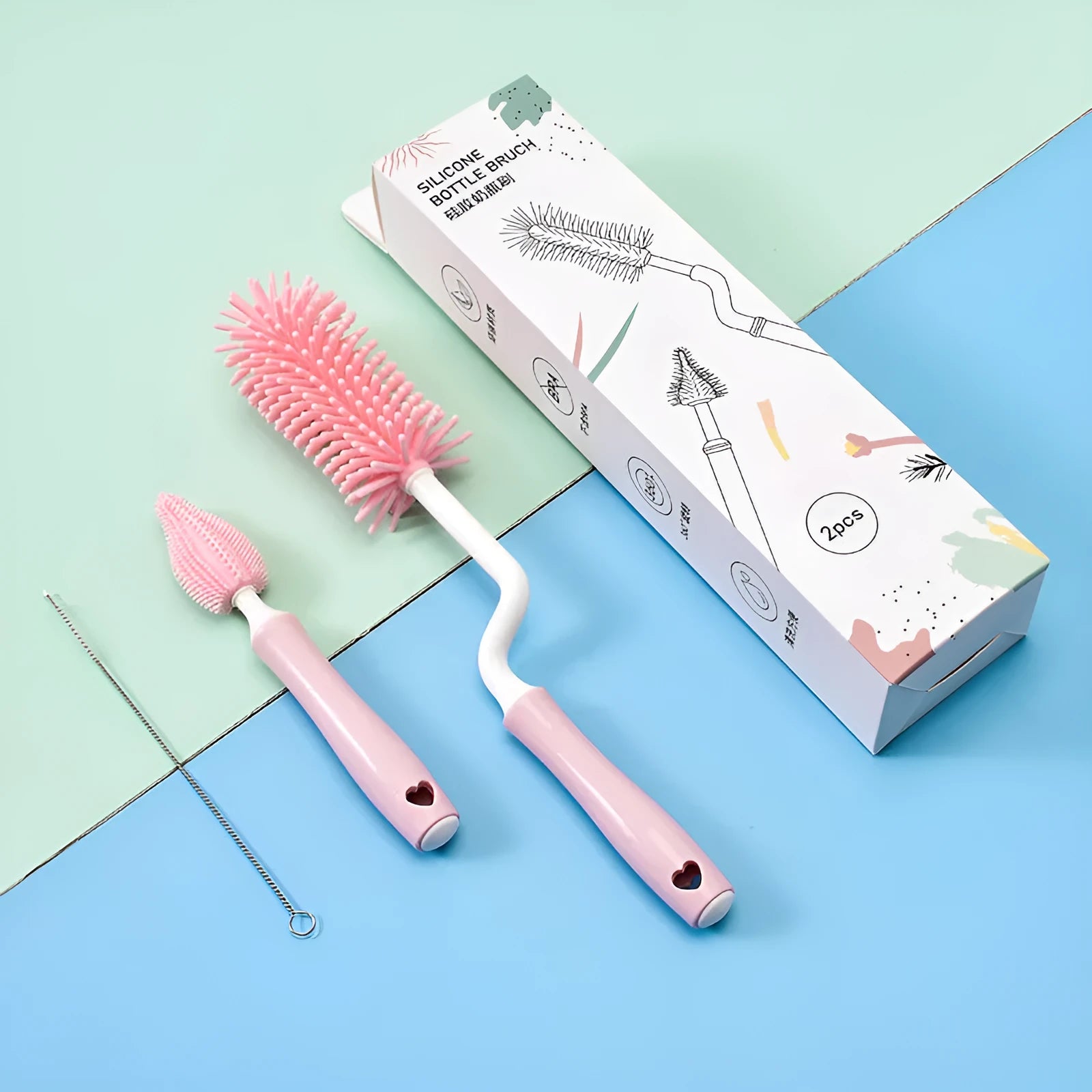 Blue, pink, and yellow silicone baby bottle brushes with an integrated straw cleaning tool.