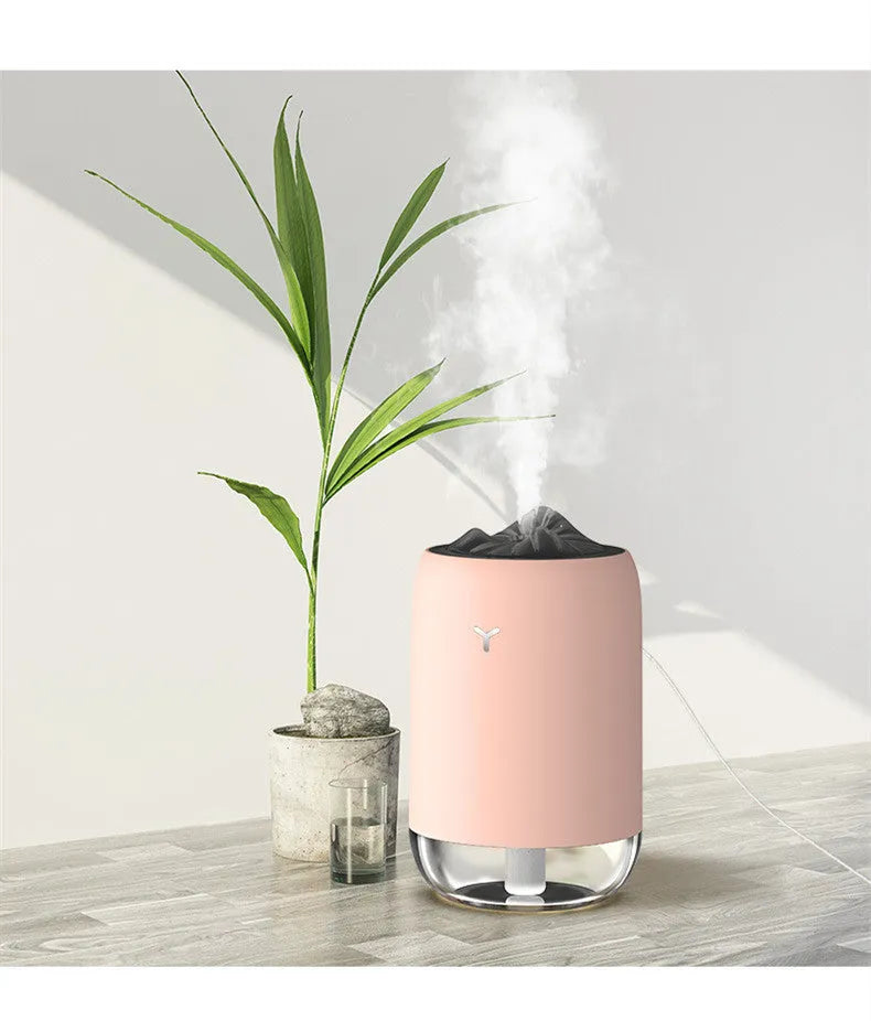 White Magic Flame columnar USB humidifier and aroma diffuser on a desk.