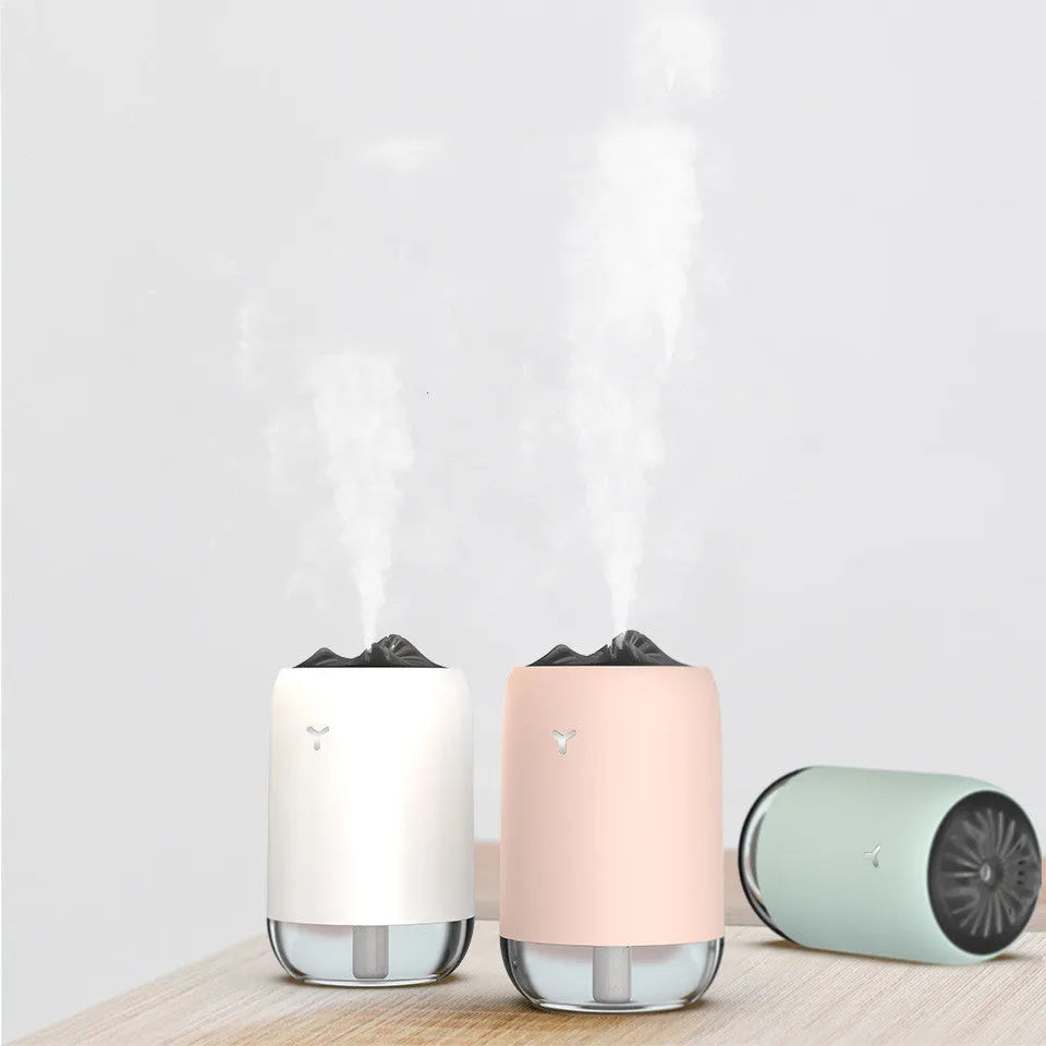 White Magic Flame columnar USB humidifier and aroma diffuser on a desk.
