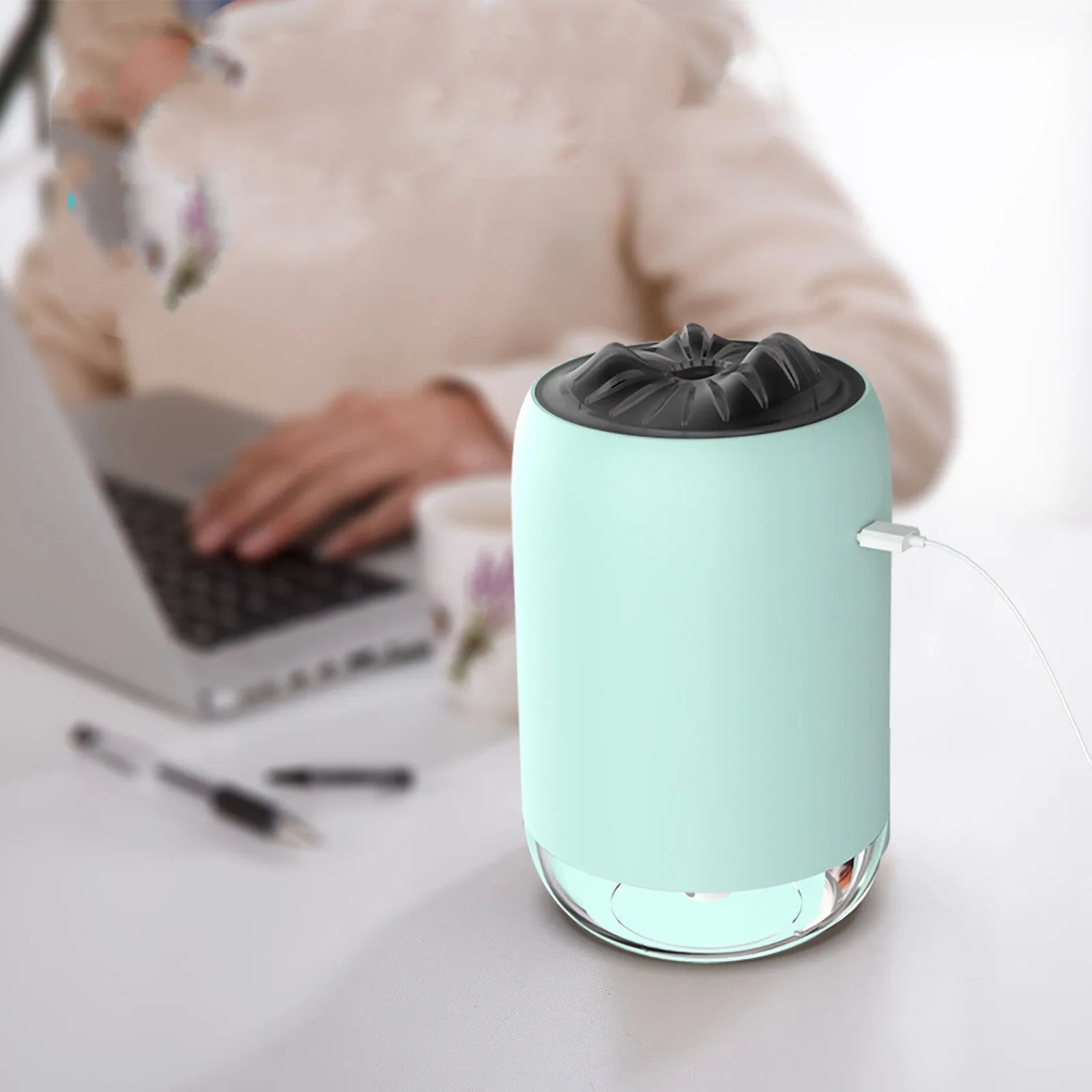 White Magic Flame columnar USB humidifier and aroma diffuser on a desk.