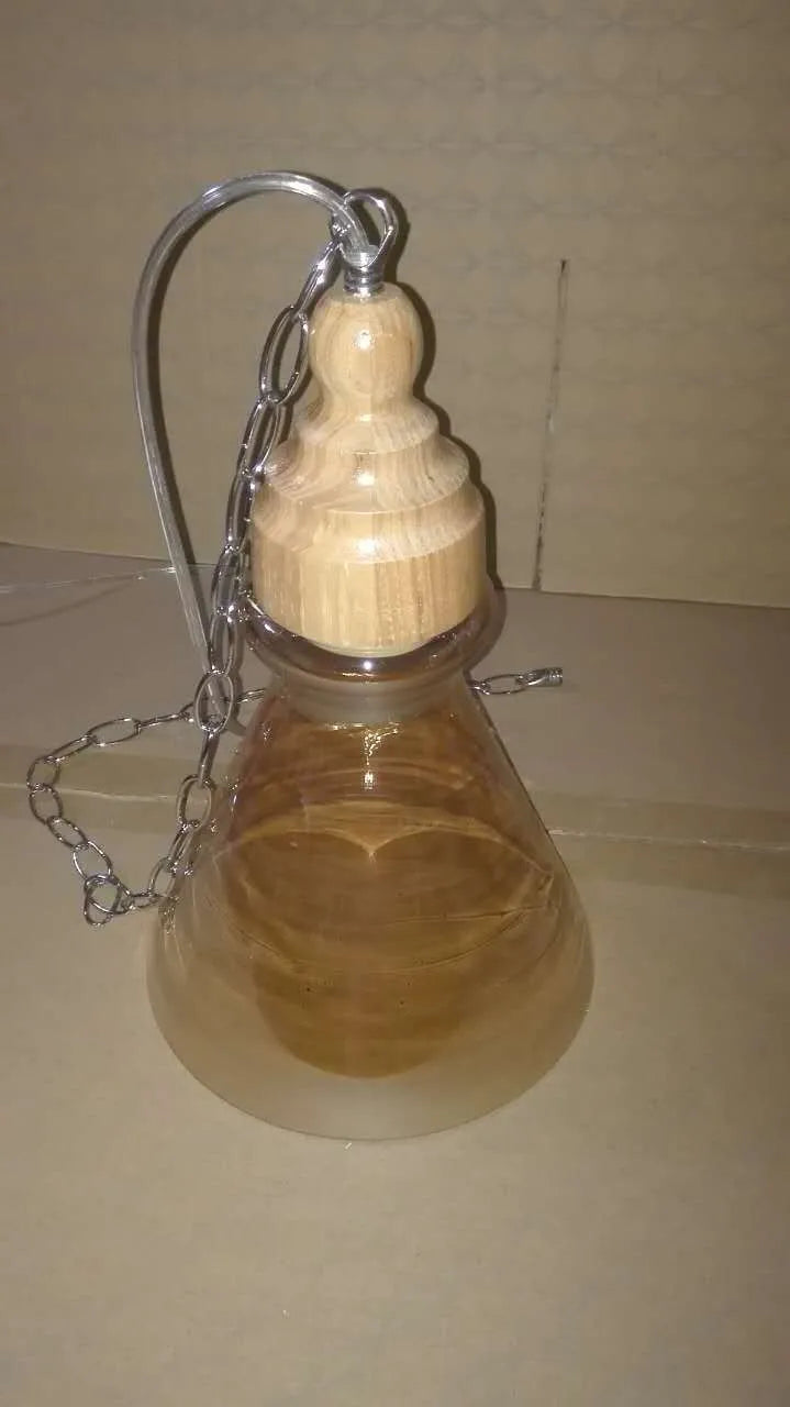 Glass wood grain single head pendant light with adjustable cord in a Nordic style.