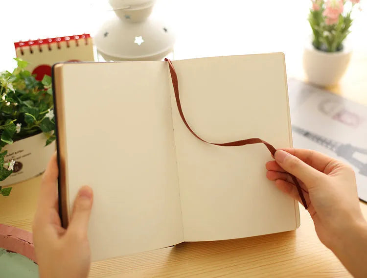 Jingu Super Thick Notebook with imitation leather cover, open showing heavyweight paper and 35mm thickness.