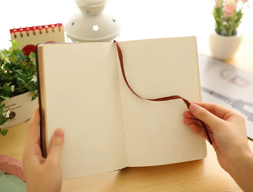 Jingu Super Thick Notebook with imitation leather cover, open showing heavyweight paper and 35mm thickness.
