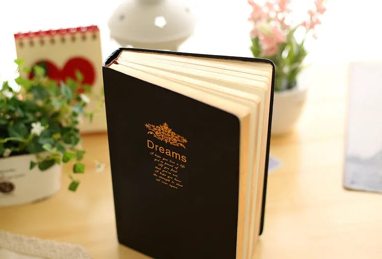 Jingu Super Thick Notebook with imitation leather cover, open showing heavyweight paper and 35mm thickness.