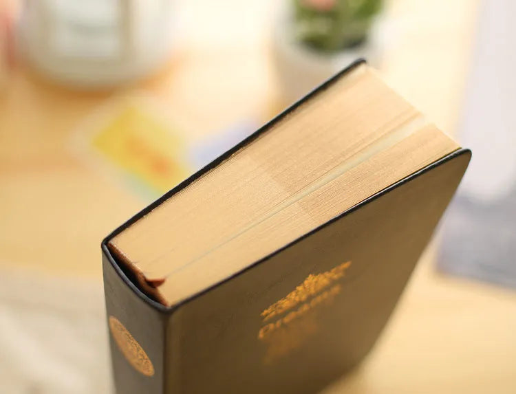 Jingu Super Thick Notebook with imitation leather cover, open showing heavyweight paper and 35mm thickness.