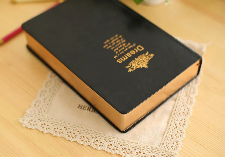 Jingu Super Thick Notebook with imitation leather cover, open showing heavyweight paper and 35mm thickness.