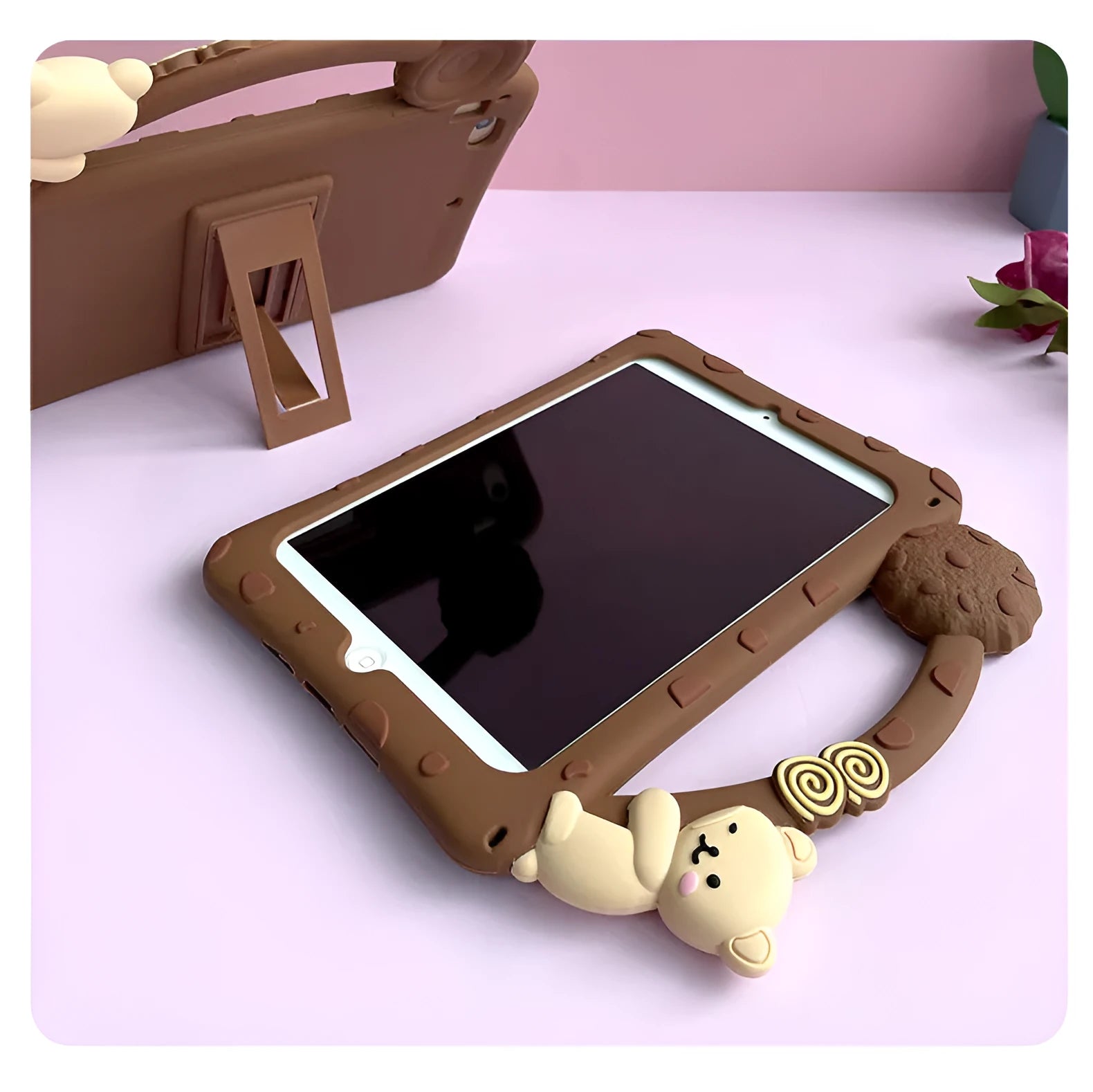 Brown cartoon-design silicone sleeve for an iPad tablet, shown with its integrated fold-out viewing bracket.