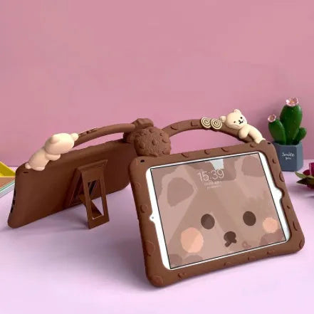 Brown cartoon-design silicone sleeve for an iPad tablet, shown with its integrated fold-out viewing bracket.