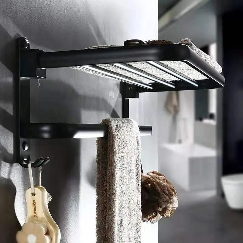 Silver anodised aluminium folding bathroom shelf with two towel racks, shown mounted on a wall.