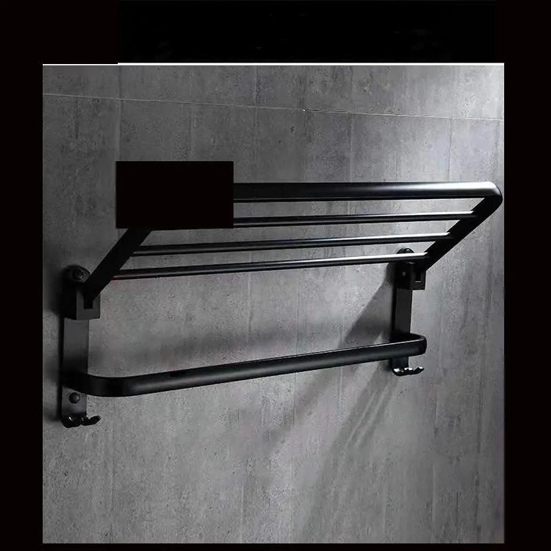 Silver anodised aluminium folding bathroom shelf with two towel racks, shown mounted on a wall.