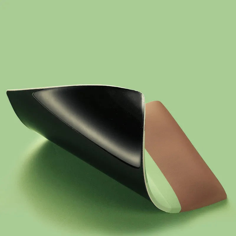 Green kiwi-shaped mouse pad with integrated wrist support and printed calculator numbers on cloth surface.