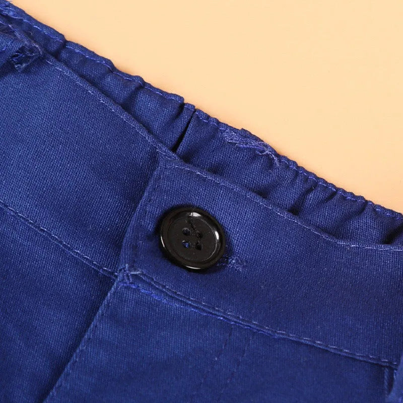 Blue boys' suit clothing set comprising a turtleneck, a vest, a tie, and trousers on a hanger.