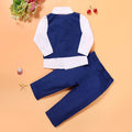 Blue boys' suit clothing set comprising a turtleneck, a vest, a tie, and trousers on a hanger.