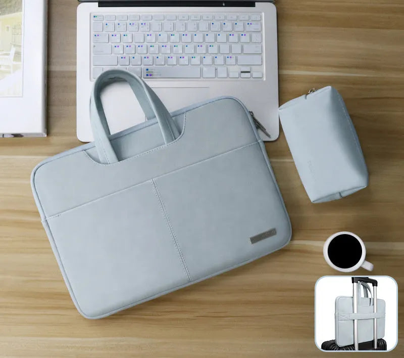 Blue PU leather laptop shoulder bag open to show internal padded computer pocket and organising compartments.