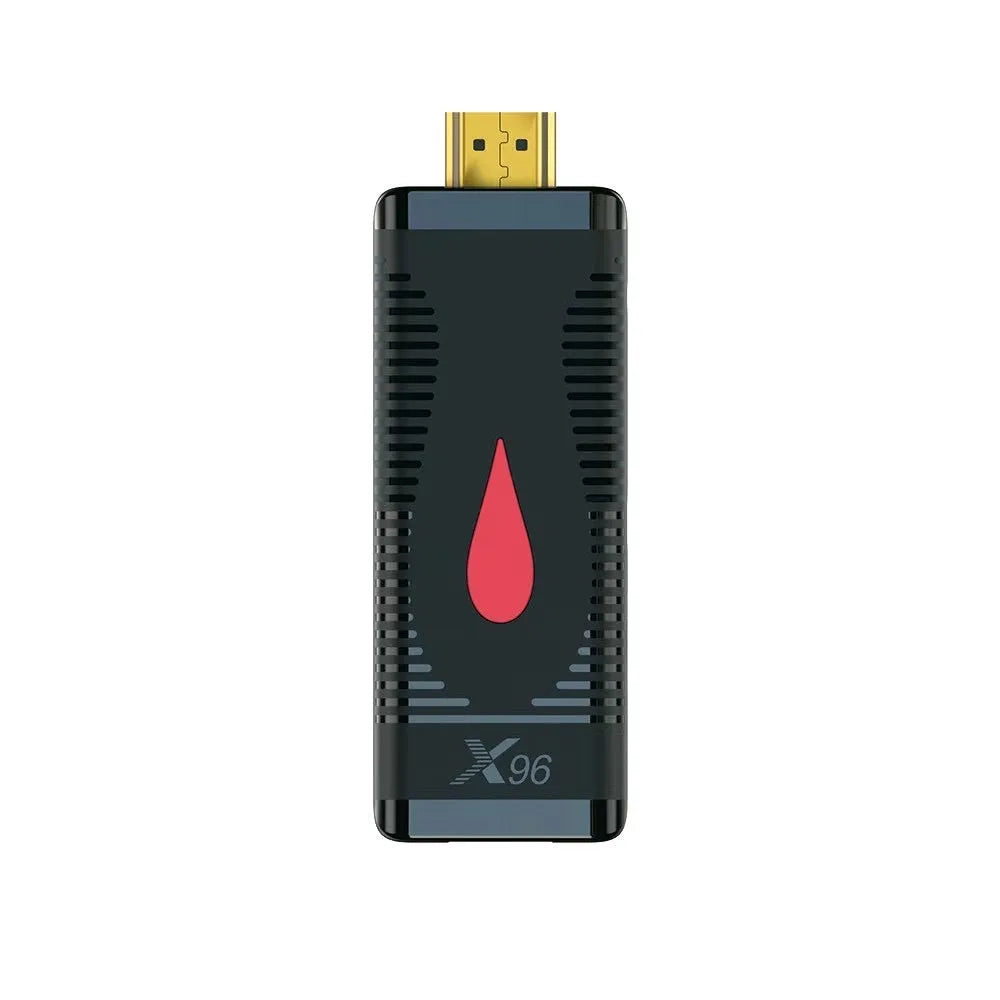 Smart network TV set-top box stick dongle with remote control and power supply on table