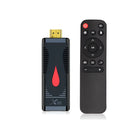 Smart network TV set-top box stick dongle with remote control and power supply on table
