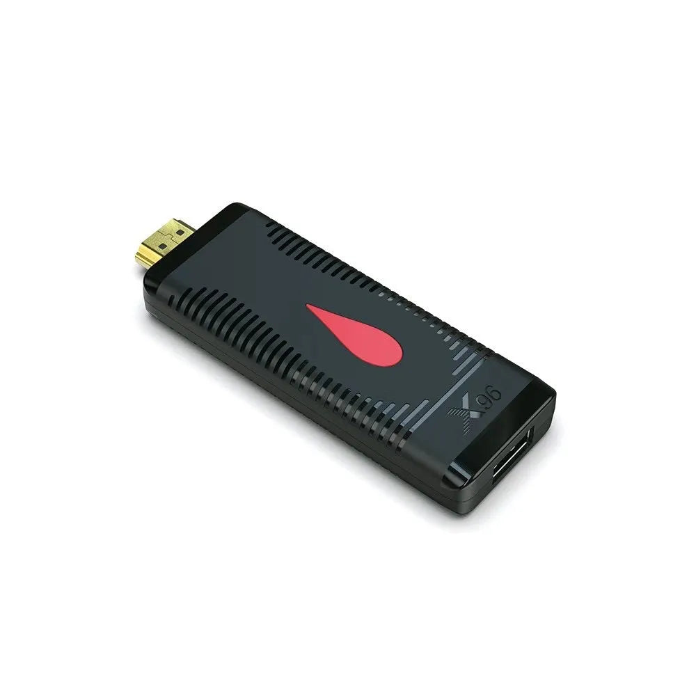 Smart network TV set-top box stick dongle with remote control and power supply on table