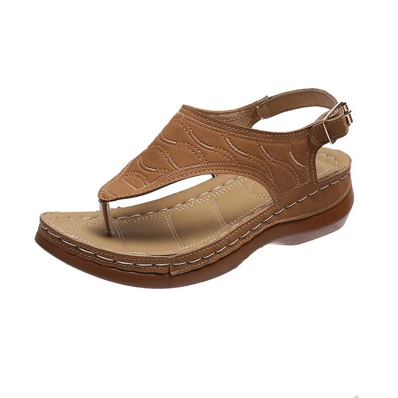 Women's wedge heel flip flop sandals in black with an adjustable buckle strap on the back.