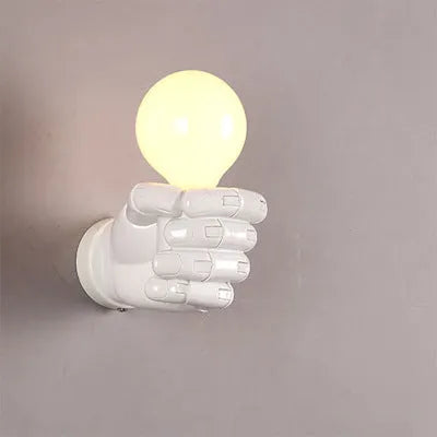 Industrial-style resin fist wall lamp in black, white, or wood grain finish for decorative lighting.