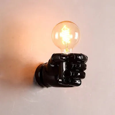 Industrial-style resin fist wall lamp in black, white, or wood grain finish for decorative lighting.