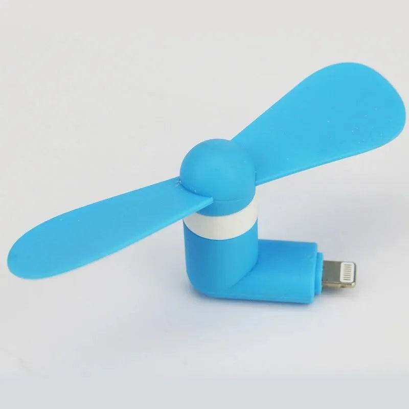 Portable mobile phone mini fan with plastic blades in various colours attached to smartphone