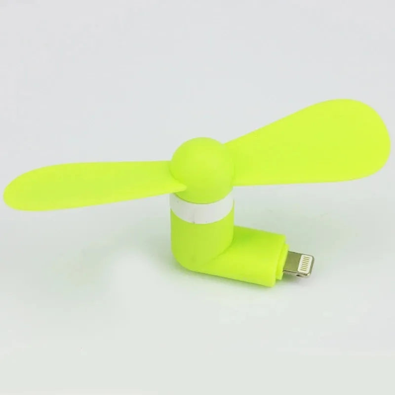 Portable mobile phone mini fan with plastic blades in various colours attached to smartphone