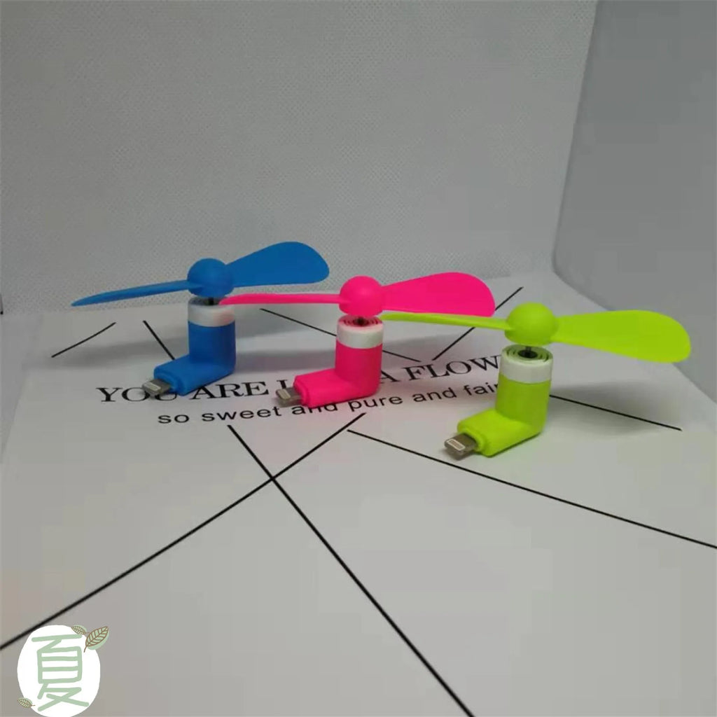 Portable mobile phone mini fan with plastic blades in various colours attached to smartphone