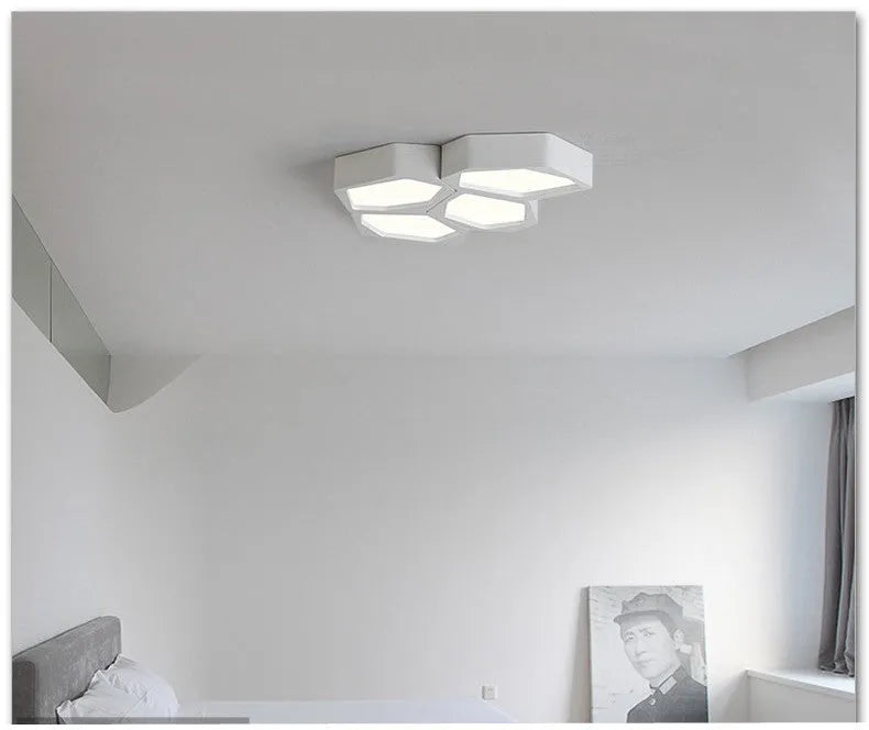 Geometric shaped LED wall light with asymmetric iron frame in black or white colour options