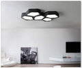 Geometric shaped LED wall light with asymmetric iron frame in black or white colour options