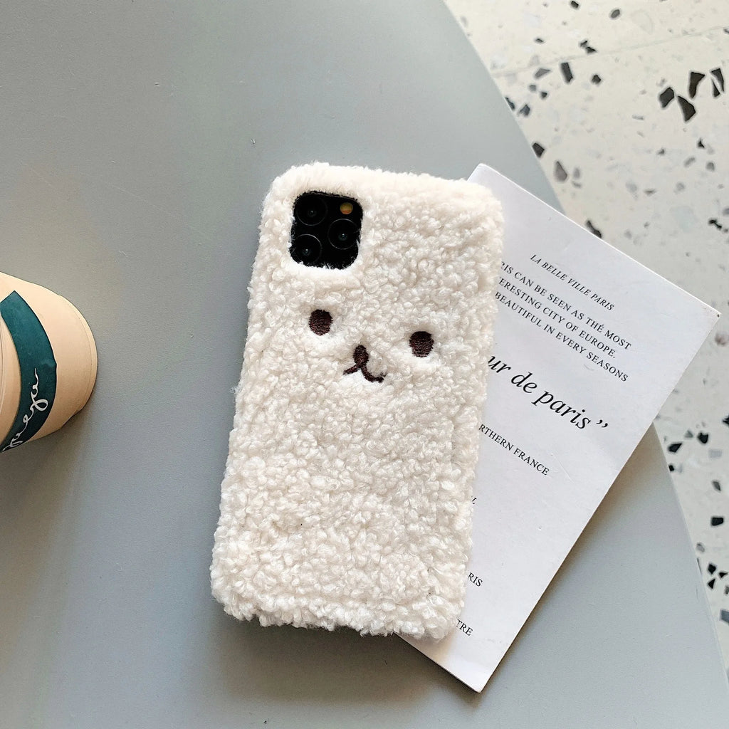 Brown embroidered plush cartoon bear face on a soft TPU iPhone case