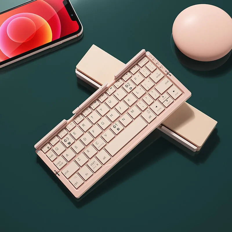 Silver aluminium folding Bluetooth keyboard open with phone on stand next to folded size comparison